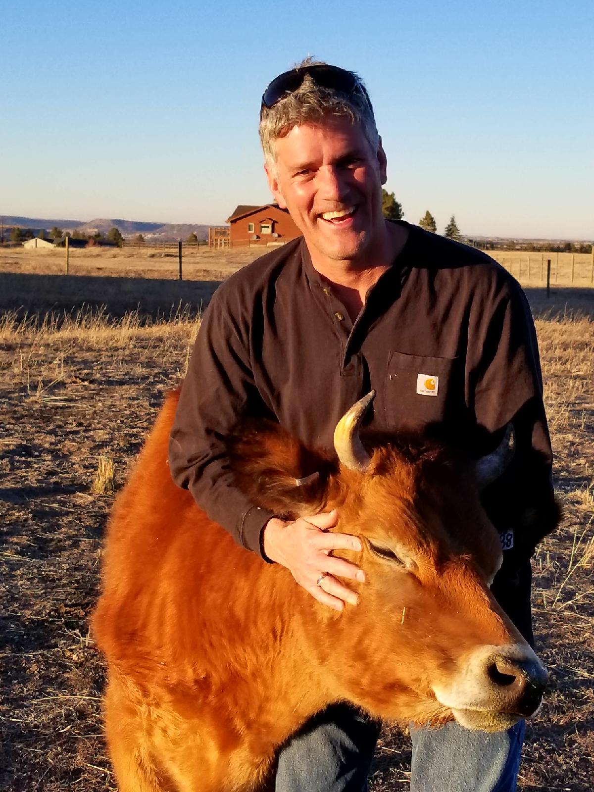 Stephen Fowler with Augie, a steer raised by his family