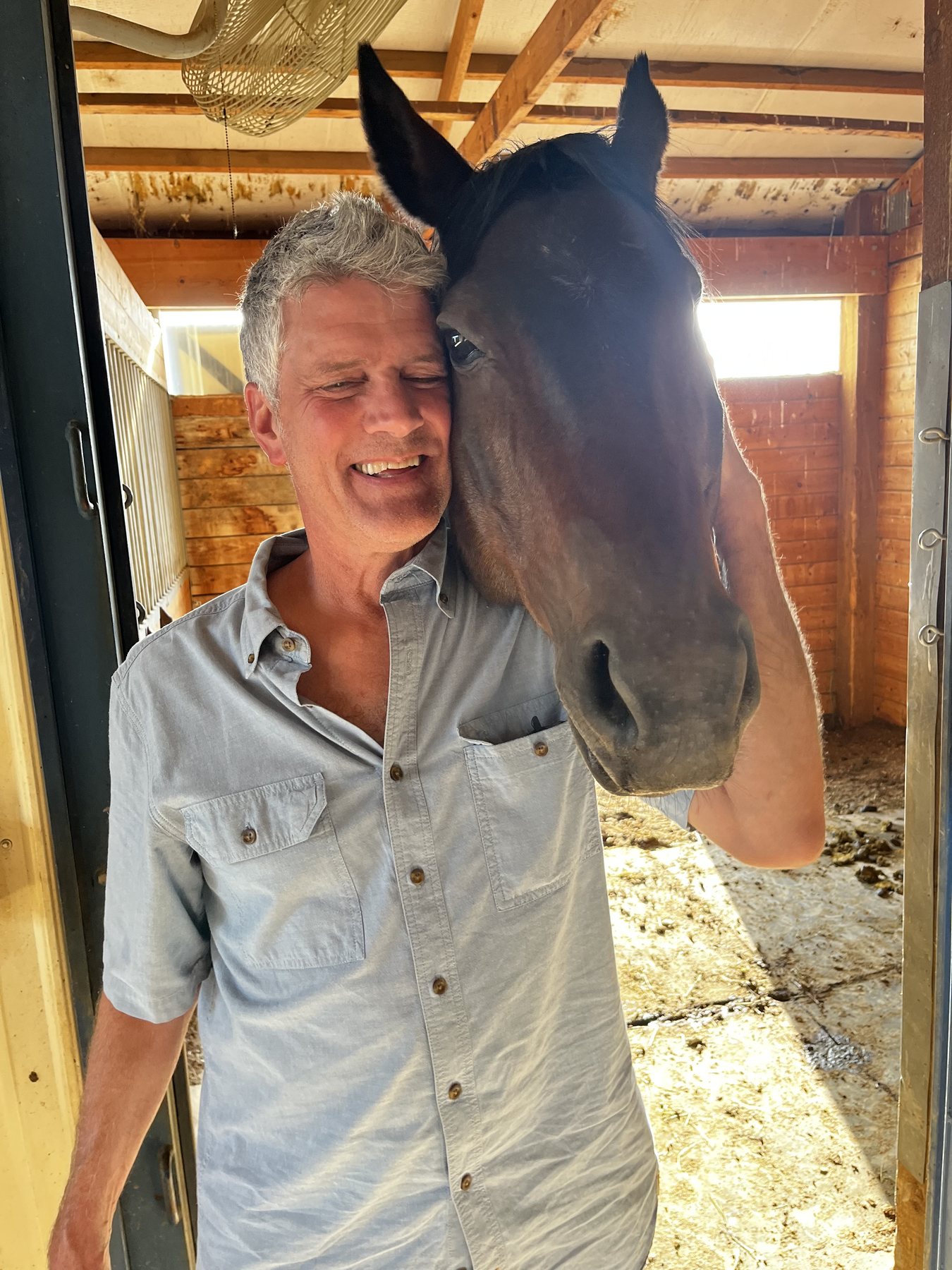 Stephen Fowler spending time with a rescued horse